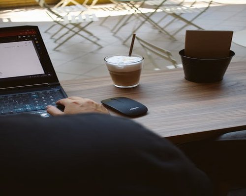 Person typing on a laptop at a cafe in Plovdiv